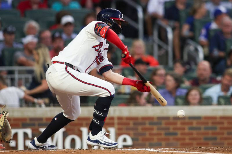 Jul 2, 2024; Atlanta, Georgia, USA; Atlanta Braves right fielder Forrest Wall (37) bunts for a base hit against the San Francisco Giants in the fifth inning at Truist Park. Mandatory Credit: Brett Davis-USA TODAY Sports