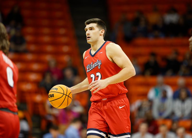 Feb 3, 2024; El Paso, Texas, USA; Liberty University Flames forward Kyle Rode (22) dribbles the ball against the UTEP Miners defense in the first half at Don Haskins Center. Mandatory Credit: Ivan Pierre Aguirre-USA TODAY Sports