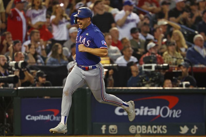 Nov 1, 2023; Phoenix, Arizona, USA; Texas Rangers first baseman Nathaniel Lowe (30) reacts as he scores a run against the Arizona Diamondbacks during the ninth inning in game five of the 2023 World Series at Chase Field. Mandatory Credit: Mark J. Rebilas-USA TODAY Sports