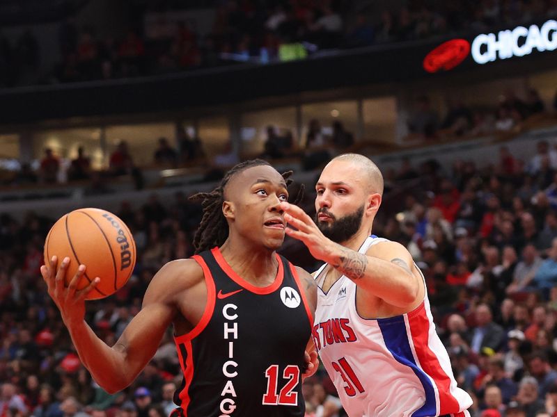 CHICAGO, ILLINOIS - FEBRUARY 27: Ayo Dosunmu #12 of the Chicago Bulls drives to the basket against Evan Fournier #31 of the Detroit Pistons during the first half at the United Center on February 27, 2024 in Chicago, Illinois. NOTE TO USER: User expressly acknowledges and agrees that, by downloading and or using this photograph, User is consenting to the terms and conditions of the Getty Images License Agreement. (Photo by Michael Reaves/Getty Images)