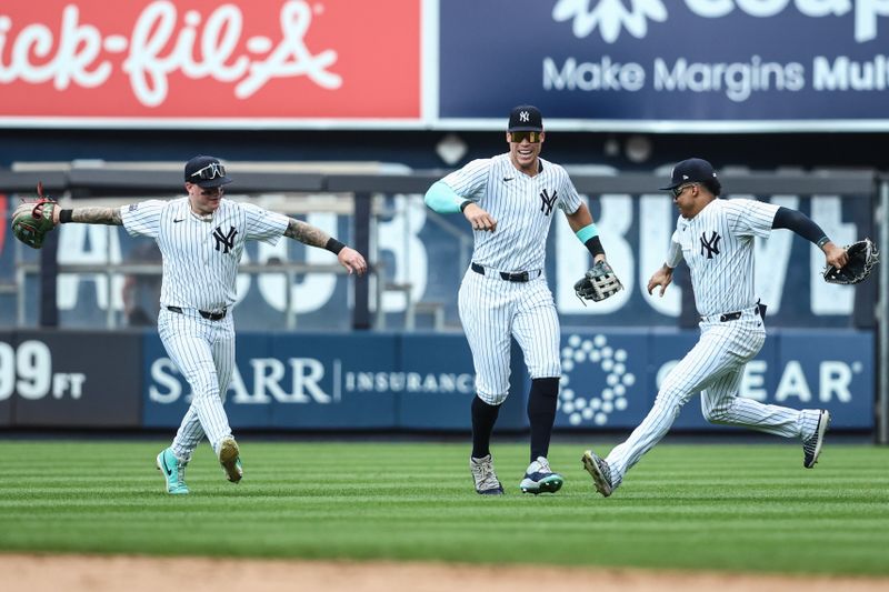 Aug 25, 2024; Bronx, New York, USA;  New York Yankees outfielders Alex Verdugo (24), Aaron Judge (99), and Juan Soto (22) celebrate after defeating the Colorado Rockies at Yankee Stadium. Mandatory Credit: Wendell Cruz-USA TODAY Sports