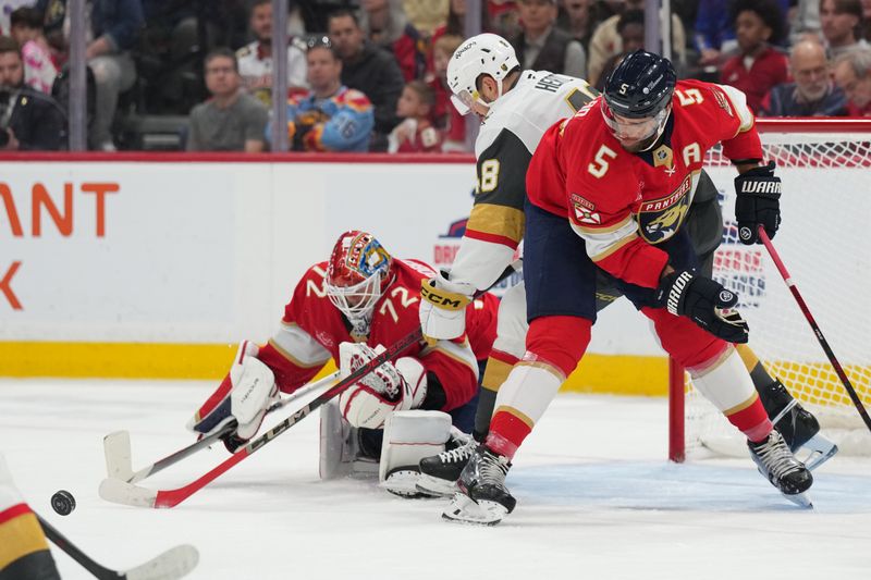 Oct 19, 2024; Sunrise, Florida, USA;  Florida Panthers goaltender Sergei Bobrovsky (72) makes a save as defenseman Aaron Ekblad (5) and Vegas Golden Knights center Tomas Hertl (48) battle for position during the first period at Amerant Bank Arena. Mandatory Credit: Jim Rassol-Imagn Images