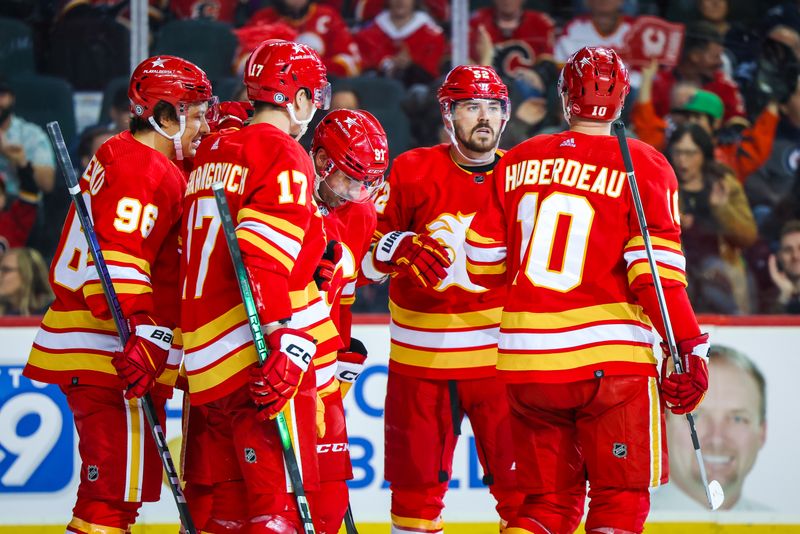 Feb 19, 2024; Calgary, Alberta, CAN; Calgary Flames center Nazem Kadri (91) celebrates his goal with teammates against the Winnipeg Jets during the second period at Scotiabank Saddledome. Mandatory Credit: Sergei Belski-USA TODAY Sports