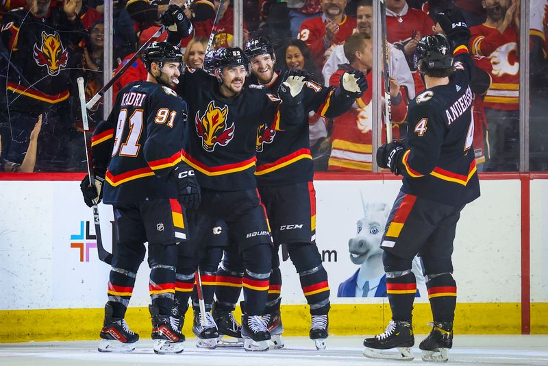 Jan 23, 2024; Calgary, Alberta, CAN; Calgary Flames defenseman MacKenzie Weegar (52) celebrates his goal with teammates against the St. Louis Blues during the first period at Scotiabank Saddledome. Mandatory Credit: Sergei Belski-USA TODAY Sports