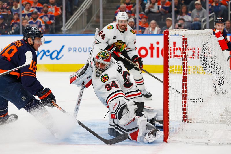 Jan 25, 2024; Edmonton, Alberta, CAN; Edmonton Oilers forward Zach Hyman (18) scores a goal during the third period against Chicago Blackhawks goaltender Petr Mrazek (34) at Rogers Place. Mandatory Credit: Perry Nelson-USA TODAY Sports