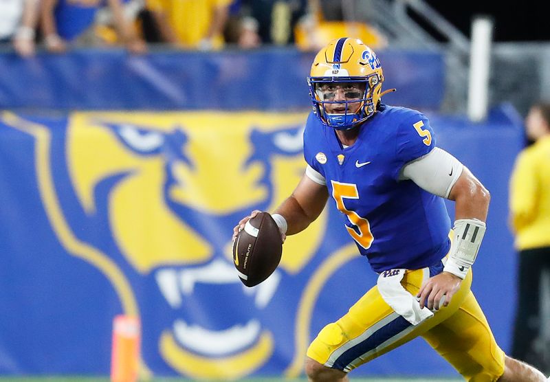 Sep 9, 2023; Pittsburgh, Pennsylvania, USA; Pittsburgh Panthers quarterback Phil Jurkovec (5) scrambles with the ball against the Cincinnati Bearcats during the second quarter at Acrisure Stadium. Mandatory Credit: Charles LeClaire-USA TODAY Sports