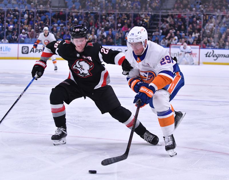 Oct 21, 2023; Buffalo, New York, USA; New York Islanders center Brock Nelson (29) and Buffalo Sabres defenseman Rasmus Dahlin (26) go for the puck in the first period at KeyBank Center. Mandatory Credit: Mark Konezny-USA TODAY Sports