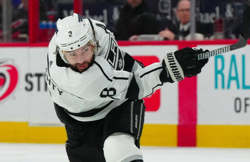 Jan 15, 2024; Raleigh, North Carolina, USA; Los Angeles Kings defenseman Drew Doughty (8) takes a shot against the Carolina Hurricanes during the second period at PNC Arena. Mandatory Credit: James Guillory-USA TODAY Sports