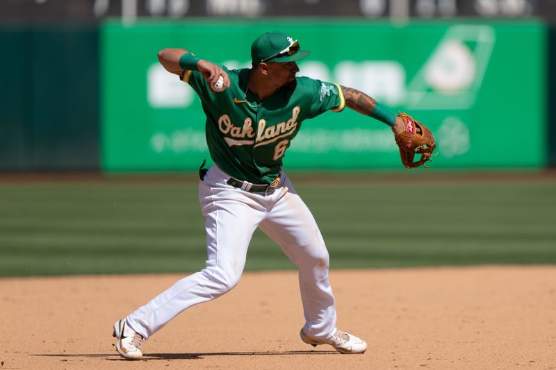 Apr 30, 2023; Oakland, California, USA;  Oakland Athletics third baseman Jace Peterson (6) throws the ball during the ninth inning against the Cincinnati Reds at RingCentral Coliseum. Mandatory Credit: Stan Szeto-USA TODAY Sports