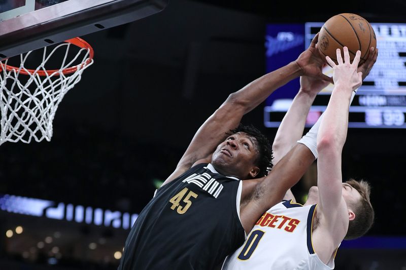 MEMPHIS, TENNESSEE - APRIL 14: Christian Braun #0 of the Denver Nuggets and GG Jackson #45 of the Memphis Grizzlies battle  for the ball during the second half at FedExForum on April 14, 2024 in Memphis, Tennessee. NOTE TO USER: User expressly acknowledges and agrees that, by downloading and or using this photograph, User is consenting to the terms and conditions of the Getty Images License Agreement. (Photo by Justin Ford/Getty Images)