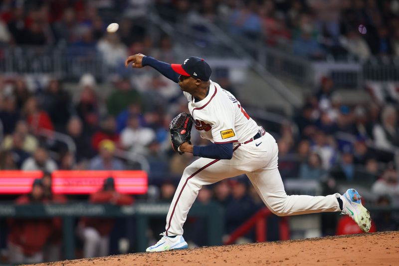 Apr 6, 2024; Atlanta, Georgia, USA; Atlanta Braves relief pitcher Raisel Iglesias (26) throws against the Arizona Diamondbacks in the ninth inning at Truist Park. Mandatory Credit: Brett Davis-USA TODAY Sports