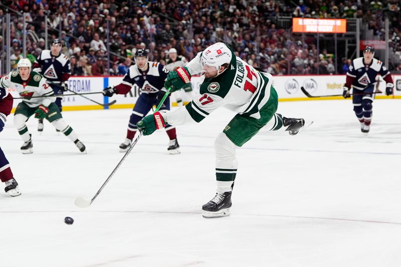 Jan 20, 2025; Denver, Colorado, USA; Minnesota Wild left wing Marcus Foligno (17) shoots the puck in the third period against the Colorado Avalanche at Ball Arena. Mandatory Credit: Ron Chenoy-Imagn Images