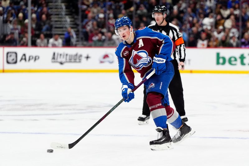 Jan 6, 2025; Denver, Colorado, USA; Colorado Avalanche defenseman Cale Makar (8) passes the puck in the second period against the Florida Panthers at Ball Arena. Mandatory Credit: Ron Chenoy-Imagn Images