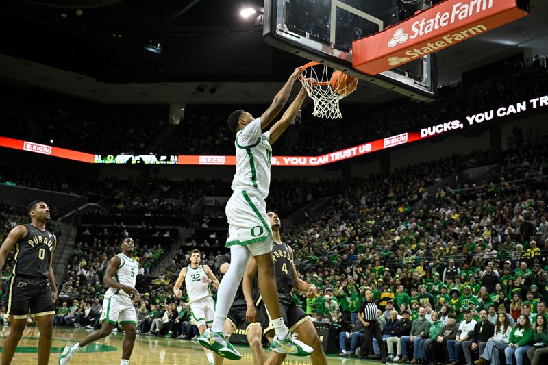 Jan 18, 2025; Eugene, Oregon, USA; Oregon Ducks forward Kwame Evans Jr. (10) dunks the ball over Purdue Boilermakers forward Trey Kaufman-Renn (4) during the first half at Matthew Knight Arena. Mandatory Credit: Craig Strobeck-Imagn Images