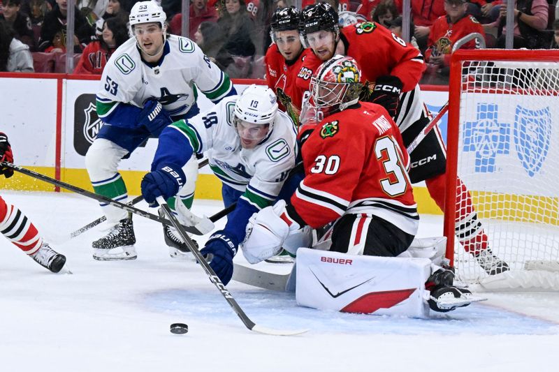 Oct 17, 2025; Chicago, Illinois, USA;  Vancouver Canucks left wing Drew O'Connor (18) shoots against Chicago Blackhawks goaltender Spencer Knight (30) during the first period at the United Center. Mandatory Credit: Matt Marton-Imagn Images