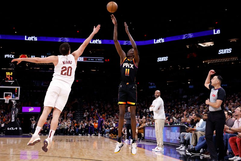 PHOENIX, ARIZONA - APRIL 03: Bol Bol #11 of the Phoenix Suns attempts a three point shot against Georges Niang #20 of the Cleveland Cavaliers during the second half at Footprint Center on April 03, 2024 in Phoenix, Arizona. NOTE TO USER: User expressly acknowledges and agrees that, by downloading and or using this photograph, User is consenting to the terms and conditions of the Getty Images License Agreement.  (Photo by Chris Coduto/Getty Images)