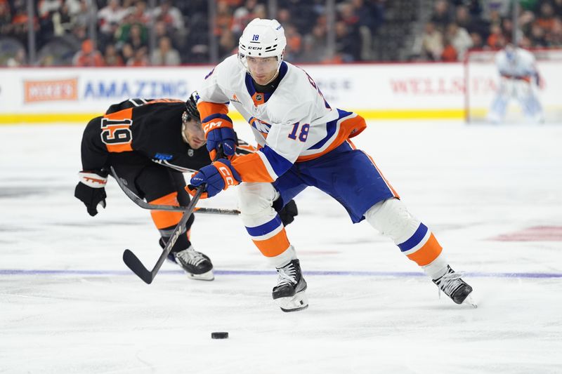 Apr 12, 2025; Philadelphia, Pennsylvania, USA; New York Islanders left wing Pierre Engvall (18) controls the puck against the Philadelphia Flyers in the third period at Wells Fargo Center. Mandatory Credit: Kyle Ross-Imagn Images