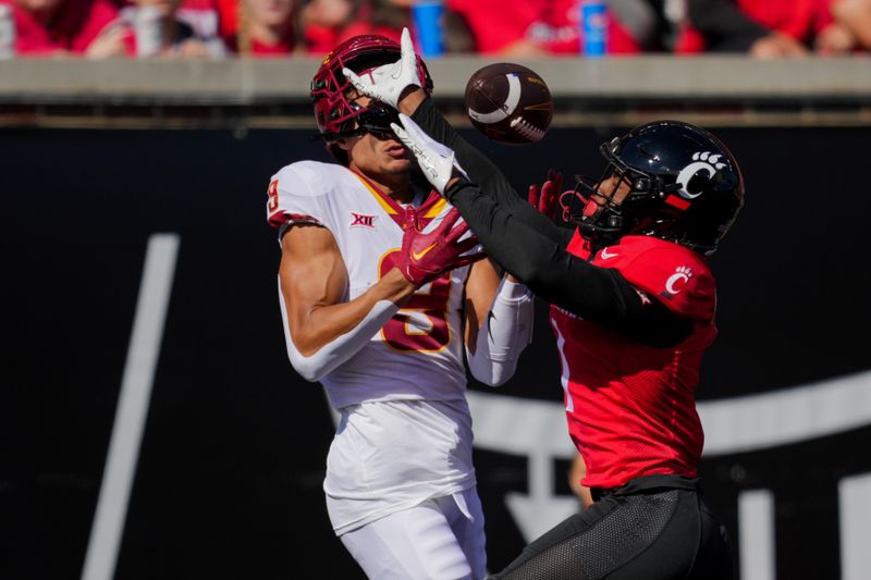 Oct 14, 2023; Cincinnati, Ohio, USA;  Cincinnati Bearcats defensive back Taj Ward (15) breaks up a pass intended for Iowa State Cyclones wide receiver Jayden Higgins (9) in the first half at Nippert Stadium. Mandatory Credit: Aaron Doster-USA TODAY Sports