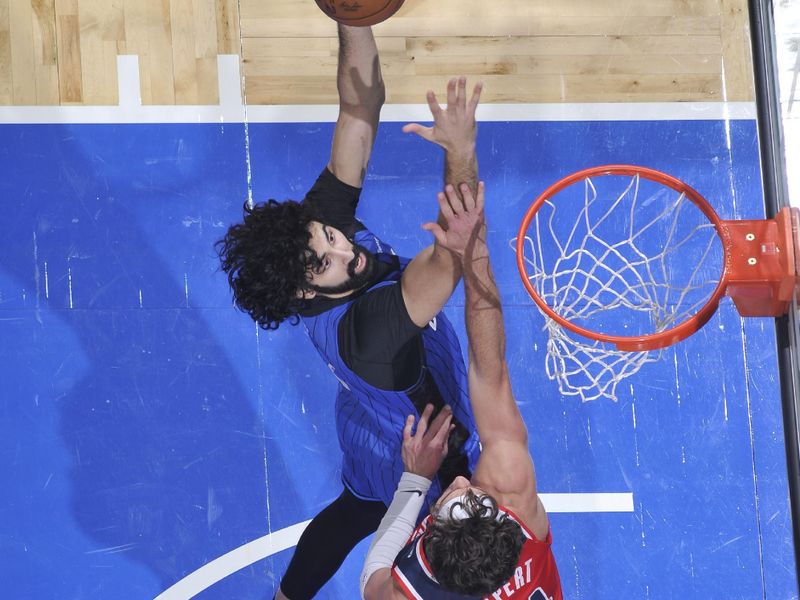 ORLANDO, FL - FEBRUARY 23:  Goga Bitadze #35 of the Orlando Magic drives to the basket during the game against the Washington Wizards on February 23, 2025 at Kia Center in Orlando, Florida. NOTE TO USER: User expressly acknowledges and agrees that, by downloading and or using this photograph, User is consenting to the terms and conditions of the Getty Images License Agreement. Mandatory Copyright Notice: Copyright 2025 NBAE (Photo by Fernando Medina/NBAE via Getty Images)