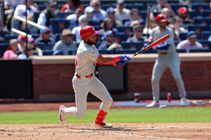 Apr 23, 2025; New York City, New York, USA; Philadelphia Phillies center fielder Johan Rojas (23) follows through on an RBI single against the New York Mets during the fourth inning at Citi Field. Mandatory Credit: Brad Penner-Imagn Images