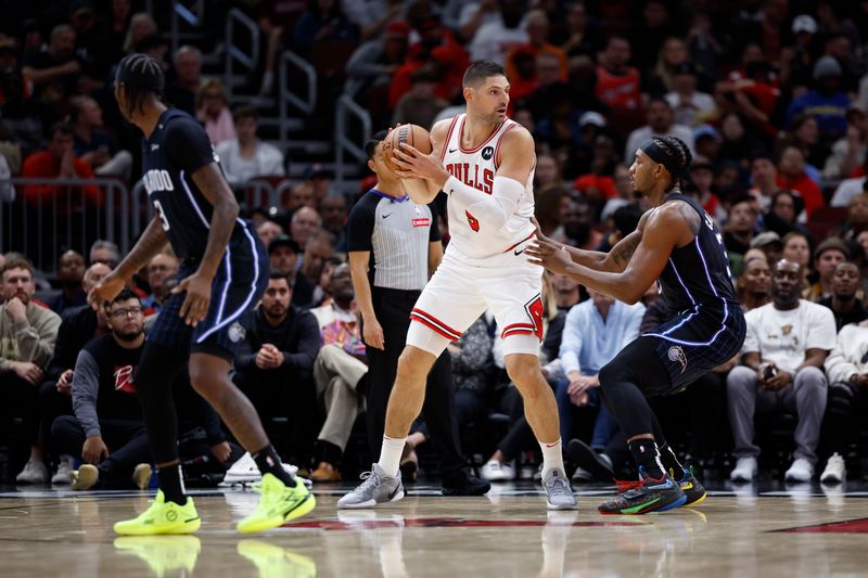 CHICAGO, IL - OCTOBER 30: Nikola Vucevic #9 of the Chicago Bulls handles the ball during the game against the Orlando Magic on October 30, 2024 at United Center in Chicago, Illinois. NOTE TO USER: User expressly acknowledges and agrees that, by downloading and or using this photograph, User is consenting to the terms and conditions of the Getty Images License Agreement. Mandatory Copyright Notice: Copyright 2024 NBAE (Photo by Kamil Krzaczynski/NBAE via Getty Images)