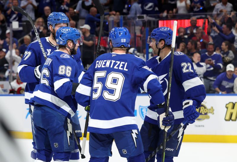Oct 9, 2025; Tampa, Florida, USA; Tampa Bay Lightning right wing Nikita Kucherov (86) is congratulated by defenseman Victor Hedman (77), center Jake Guentzel (59) and right wing Oliver Bjorkstrand (22) after he scored a goal against the Ottawa Senators during the first period at Benchmark International Arena. Mandatory Credit: Kim Klement Neitzel-Imagn Images
