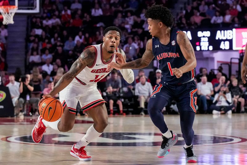 Jan 4, 2023; Athens, Georgia, USA; Georgia Bulldogs guard Justin Hill (11) dribbles against Auburn Tigers guard Wendell Green Jr. (1) during the second half at Stegeman Coliseum. Mandatory Credit: Dale Zanine-USA TODAY Sports