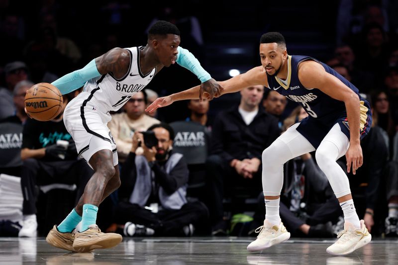 NEW YORK, NEW YORK - MARCH 19: Dennis Schroder #17 of the Brooklyn Nets dribbles against CJ McCollum #3 of the New Orleans Pelicans during the first half at Barclays Center on March 19, 2024 in the Brooklyn borough of New York City. NOTE TO USER: User expressly acknowledges and agrees that, by downloading and/or using this Photograph, user is consenting to the terms and conditions of the Getty Images License Agreement. (Photo by Sarah Stier/Getty Images)