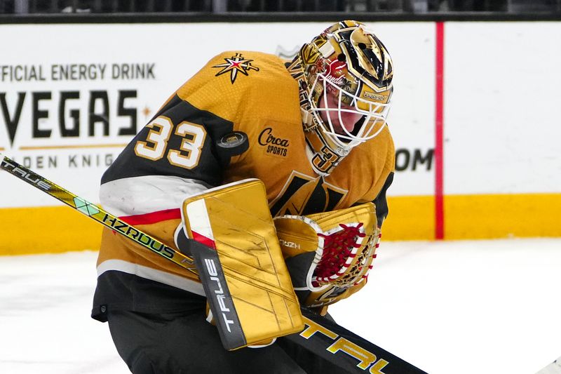 Mar 23, 2024; Las Vegas, Nevada, USA; Vegas Golden Knights goaltender Adin Hill (33) makes a save against the Columbus Blue Jackets during the first period at T-Mobile Arena. Mandatory Credit: Stephen R. Sylvanie-USA TODAY Sports