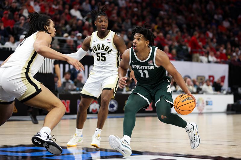 Mar 15, 2024; Minneapolis, MN, USA; Michigan State Spartans guard A.J. Hoggard (11) works towards the basket as Purdue Boilermakers forward Trey Kaufman-Renn (4) and guard Lance Jones (55) defend during the second half at Target Center. Mandatory Credit: Matt Krohn-USA TODAY Sports