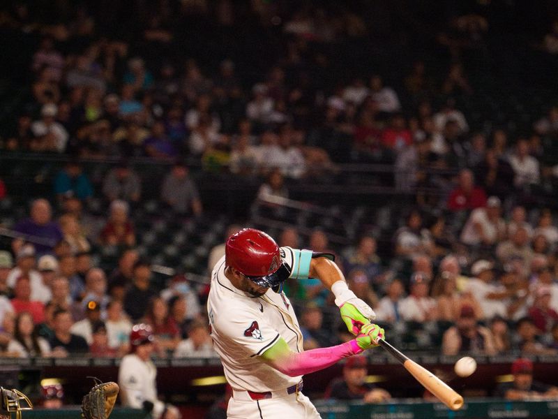 Aug 5, 2025; Phoenix, Arizona, USA; Arizona Diamondbacks outfielder Lourdes Gurriel Jr. (12) hits a a home run in the fifth inning against the San Diego Padres at Chase Field. Mandatory Credit: Allan Henry-Imagn Images