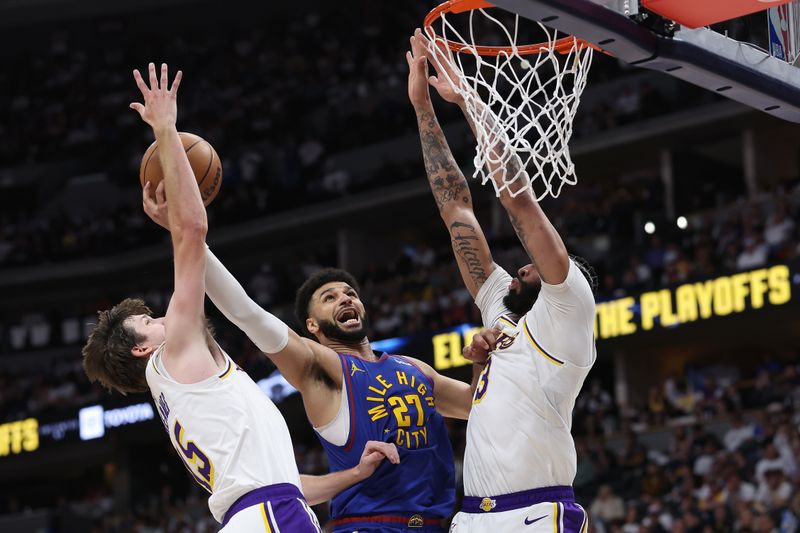 DENVER, COLORADO - APRIL 20: Jamal Murray #27 of the Denver Nuggets goes to the basket against Austin Reaves #15 and Anthony Davis #3 of the Los Angeles Lakers in the third quarter during game one of the Western Conference First Round Playoffs at Ball Arena on April 20, 2024 in Denver, Colorado.  NOTE TO USER: User expressly acknowledges and agrees that, by downloading and or using this photograph, User is consenting to the terms and conditions of the Getty Images License Agreement. (Photo by Matthew Stockman/Getty Images)