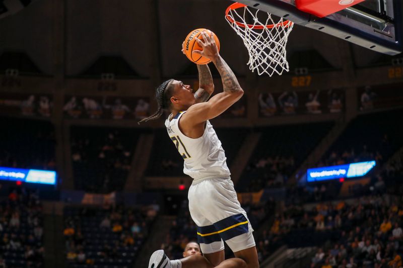 Mar 6, 2024; Morgantown, West Virginia, USA; West Virginia Mountaineers guard RaeQuan Battle (21) dunks the ball during the second half against the TCU Horned Frogs at WVU Coliseum. Mandatory Credit: Ben Queen-USA TODAY Sports