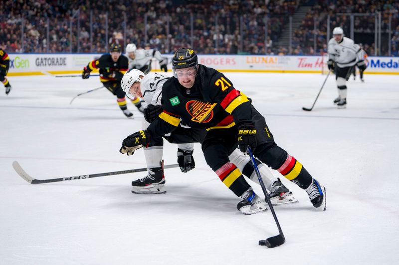 Mar 25, 2024; Vancouver, British Columbia, CAN; Vancouver Canucks forward Nils Hoglander (21) drives past Los Angeles Kings defenseman Mikey Anderson (44) in the first period at Rogers Arena. Mandatory Credit: Bob Frid-USA TODAY Sports