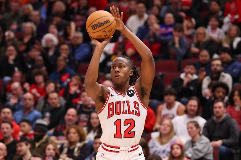 CHICAGO, ILLINOIS - FEBRUARY 03: Ayo Dosunmu #12 of the Chicago Bulls shoots a three pointer against the Sacramento Kings during the second half at the United Center on February 03, 2024 in Chicago, Illinois. NOTE TO USER: User expressly acknowledges and agrees that, by downloading and or using this photograph, User is consenting to the terms and conditions of the Getty Images License Agreement.  (Photo by Michael Reaves/Getty Images)