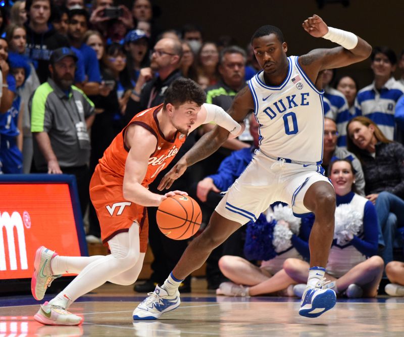 Feb 25, 2023; Durham, North Carolina, USA; Virginia Tech Hokies guard Hunter Cattoor (0) drives to the basket as Duke Blue Devils forward Dariq Whitehead (0) defends during the first half at Cameron Indoor Stadium. Mandatory Credit: Rob Kinnan-USA TODAY Sports