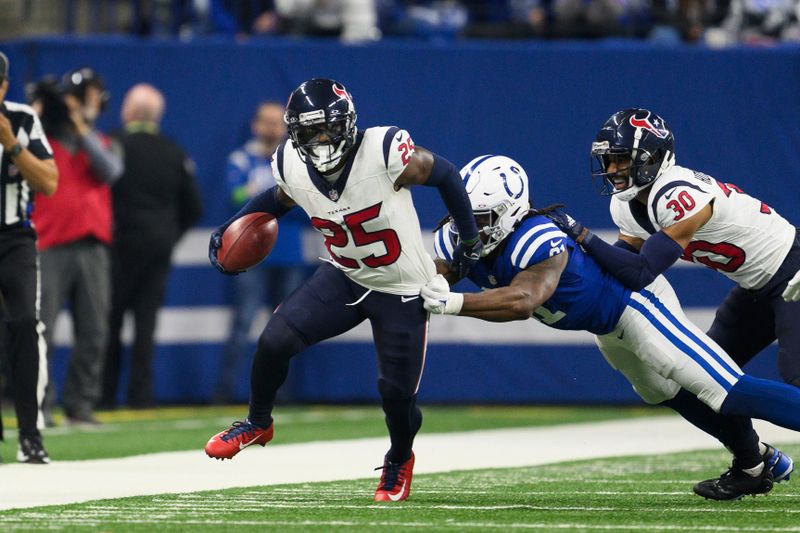 Houston Texans safety Grayland Arnold (25) returns a punt down the sidelines as Indianapolis Colts tight end Mo Alie-Cox (81) pulls him down during an NFL football game, Saturday, Jan. 6, 2024, in Indianapolis. (AP Photo/Zach Bolinger)