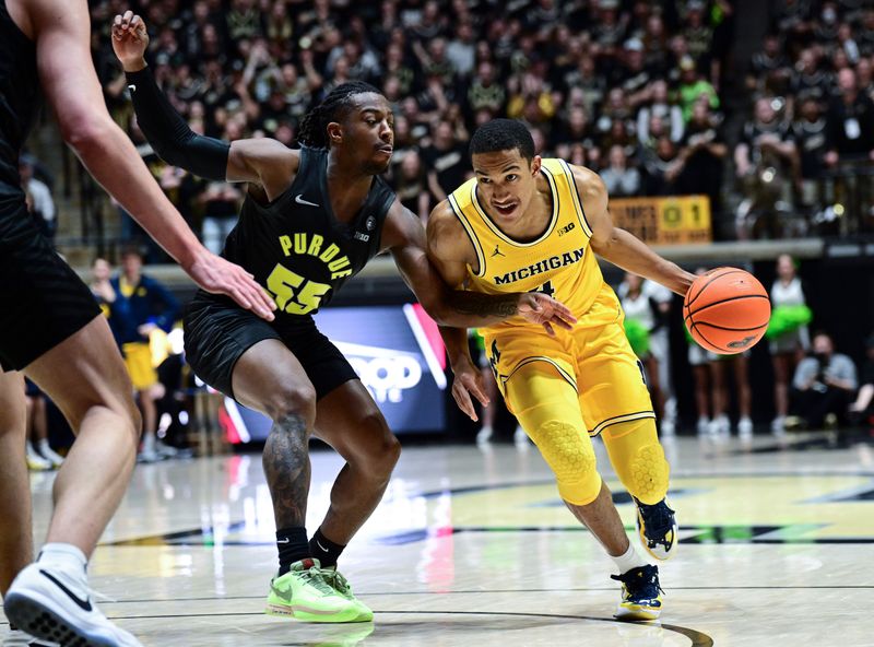 Jan 23, 2024; West Lafayette, Indiana, USA; Michigan Wolverines guard Nimari Burnett (4) drives the ball toward the basket against Purdue Boilermakers guard Lance Jones (55) during the first half at Mackey Arena. Mandatory Credit: Marc Lebryk-USA TODAY Sports