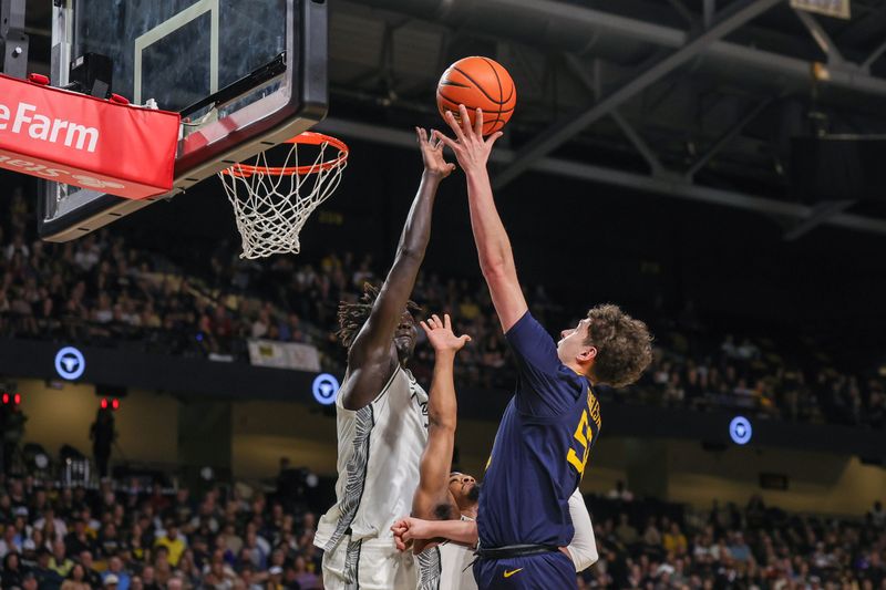 Feb 14, 2026; Orlando, Florida, USA; West Virginia Mountaineers guard Treysen Eaglestaff (52) goes to the basket against UCF Knights center John Bol (7) during the first half at Addition Financial Arena. Mandatory Credit: Mike Watters-Imagn Images