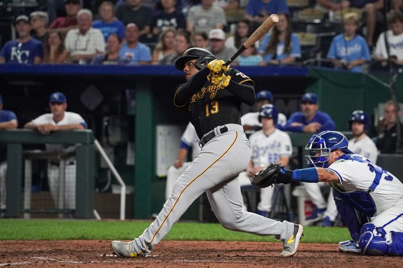 Aug 29, 2023; Kansas City, Missouri, USA; Pittsburgh Pirates third baseman Ke'Bryan Hayes (13) hits a two-run home run against the Kansas City Royals in the eighth inning at Kauffman Stadium. Mandatory Credit: Denny Medley-USA TODAY Sports