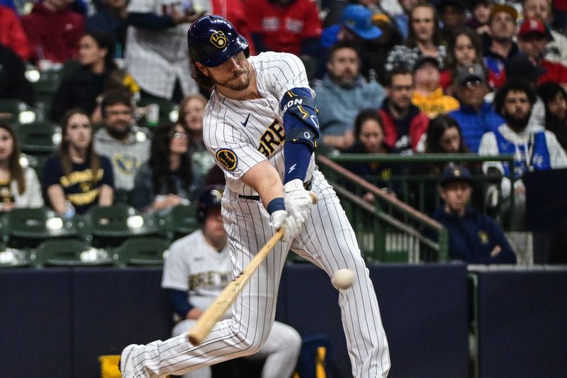 Apr 22, 2023; Milwaukee, Wisconsin, USA;  Milwaukee Brewers third baseman Brian Anderson (9) hits a double to drive in a run in the second inning during game against the Boston Red Sox at American Family Field. Mandatory Credit: Benny Sieu-USA TODAY Sports