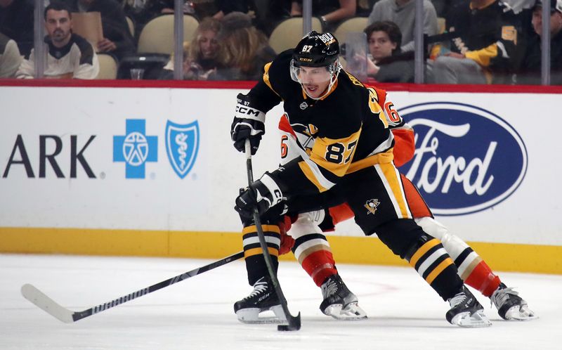 Oct 31, 2024; Pittsburgh, Pennsylvania, USA;  Pittsburgh Penguins center Sidney Crosby (87) moves the puck against Anaheim Ducks defenseman Brian Dumoulin (6) during the second period at PPG Paints Arena. Mandatory Credit: Charles LeClaire-Imagn Images