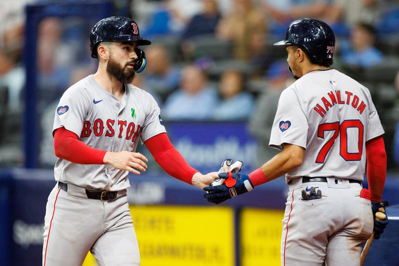 May 22, 2024; St. Petersburg, Florida, USA;  Boston Red Sox catcher Connor Wong (12) celebrates with shortstop David Hamilton (70) after scoring a run against the Tampa Bay Rays in the fifth inning at Tropicana Field. Mandatory Credit: Nathan Ray Seebeck-USA TODAY Sports