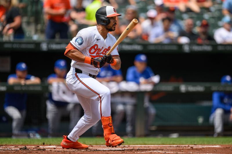 Jul 31, 2024; Baltimore, Maryland, USA; Baltimore Orioles outfielder Anthony Santander (25) hits a single against the Toronto Blue Jays during the first inning at Oriole Park at Camden Yards. Mandatory Credit: Reggie Hildred-USA TODAY Sports