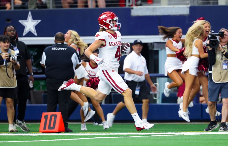Sep 28, 2024; Arlington, Texas, USA;  Arkansas Razorbacks wide receiver Isaac TeSlaa (4) catches a pass and scores a touchdown during the first quarter against the Texas A&M Aggies at AT&T Stadium. Mandatory Credit: Kevin Jairaj-Imagn Images