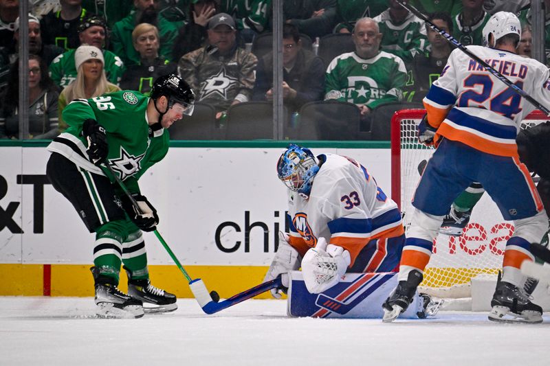 Nov 18, 2025; Dallas, Texas, USA; New York Islanders goaltender David Rittich (33) controls the puck in front of Dallas Stars right wing Mikko Rantanen (96) during the first period at the American Airlines Center. Mandatory Credit: Jerome Miron-Imagn Images