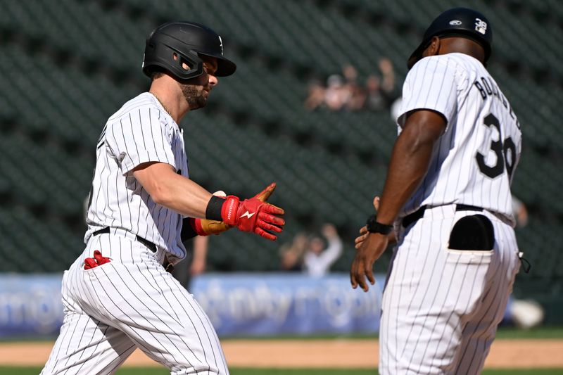 Aug 29, 2024; Chicago, Illinois, USA;  Chicago White Sox outfielder Andrew Benintendi (23) high-fives Chicago White Sox first base coach/outfield coach Jason Bourgeois (38) after he hits a home run against the Texas Rangers during the ninth inning at Guaranteed Rate Field. Mandatory Credit: Matt Marton-USA TODAY Sports