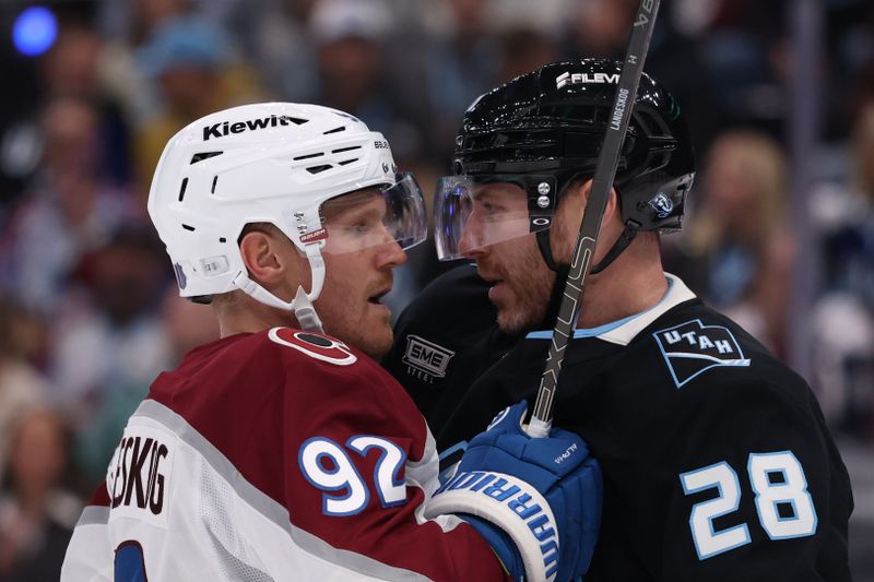 Oct 21, 2025; Salt Lake City, Utah, USA; Colorado Avalanche left wing Gabriel Landeskog (92) and Utah Mammoth defenseman Ian Cole (28) exchange words during the second period at Delta Center. Mandatory Credit: Rob Gray-Imagn Images
