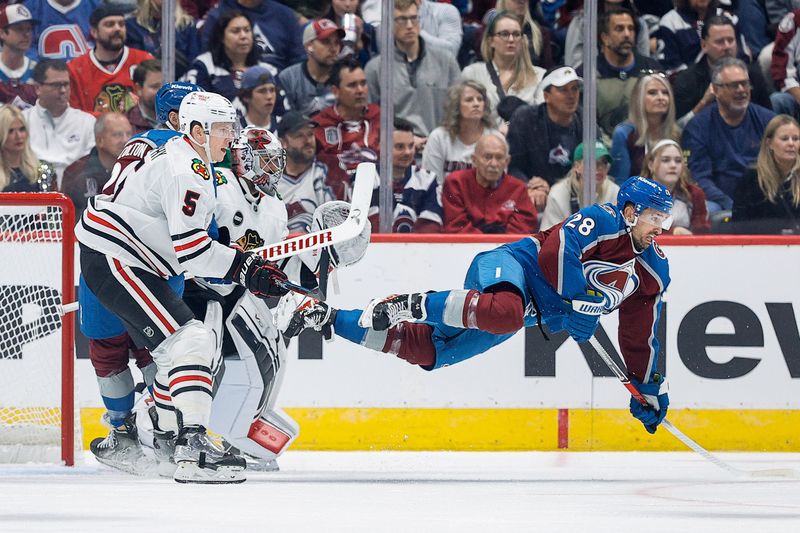 Oct 19, 2023; Denver, Colorado, USA; Colorado Avalanche left wing Miles Wood (28) gets tripped up as Chicago Blackhawks goaltender Petr Mrazek (34) and defenseman Connor Murphy (5) and center Ross Colton (20) defend in the first period at Ball Arena. Mandatory Credit: Isaiah J. Downing-USA TODAY Sports