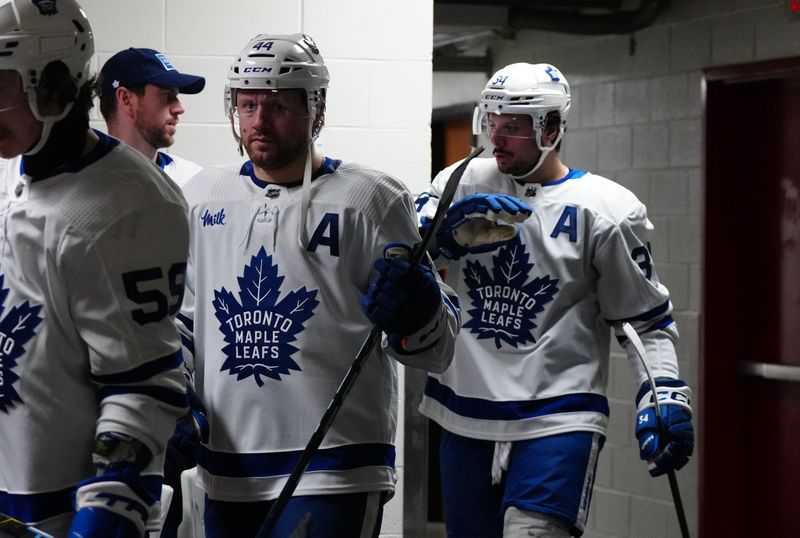 Mar 24, 2024; Raleigh, North Carolina, USA;  Toronto Maple Leafs defenseman Morgan Rielly (44) and center Auston Matthews (34) come out of the locker room before the start of the third period against the Carolina Hurricanes at PNC Arena. Mandatory Credit: James Guillory-USA TODAY Sports